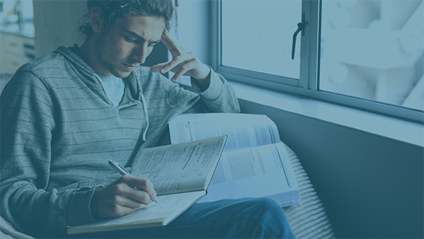  A man is studying by the window. 